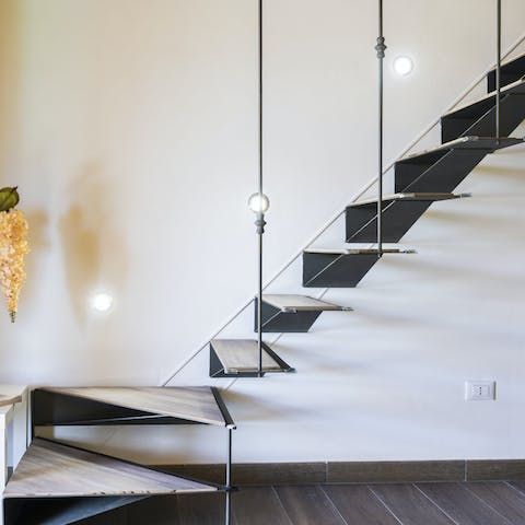 Ascend the floating staircase in style, up to the mezzanine bedroom
