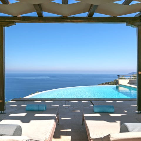 Spend breezy afternoons poolside, swimming in the infinity-style pool or lounging in the shade