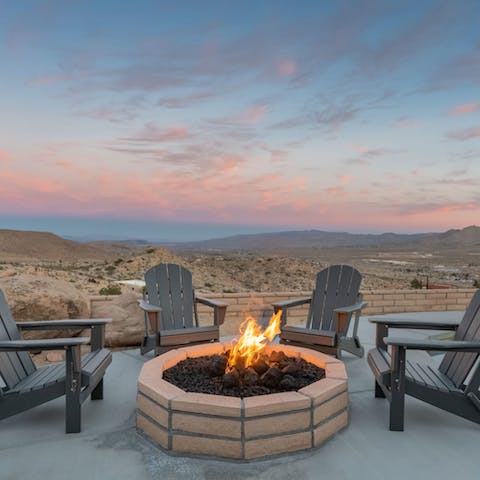 Gather around the fire pit to watch the sunset over the desert