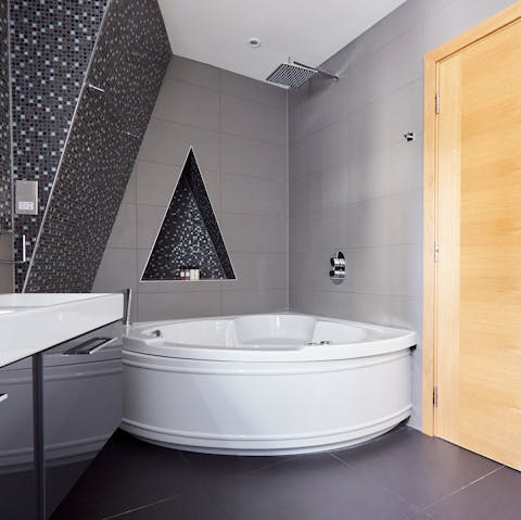 Treat yourself to a soak in the corner Jacuzzi tub after a day of sightseeing