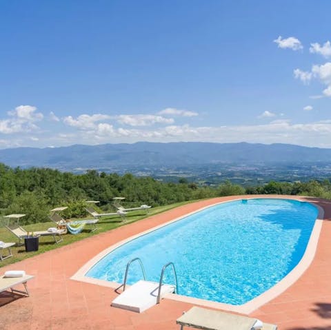 Relax on a sun lounger by the private outdoor pool while enjoying the views
