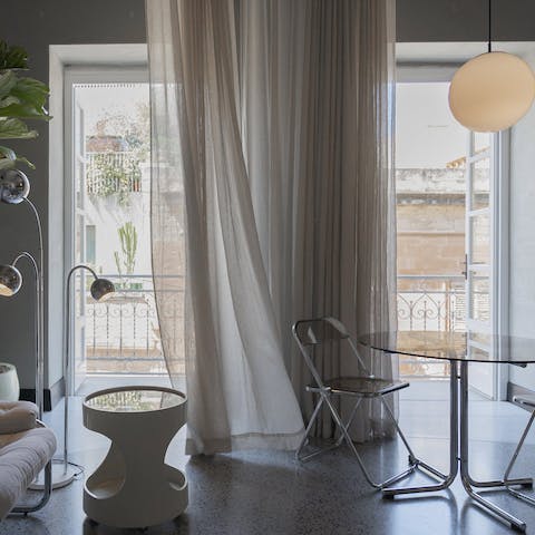 Open up the French doors to the slender balcony for a breath of fresh air