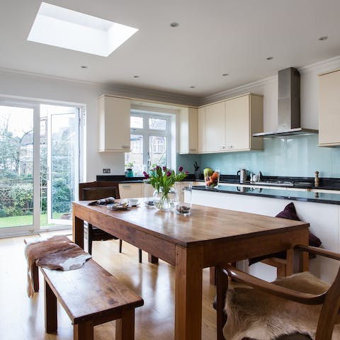 Enjoy family feasts around the long dining table, illuminated from above by the skylight