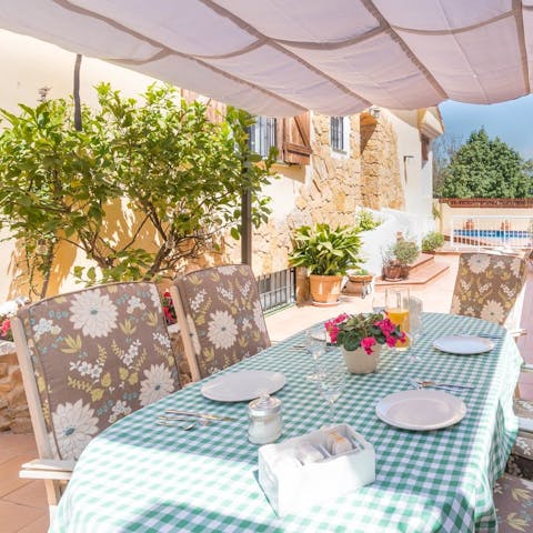 Dine alfresco at the dining table on the covered terrace