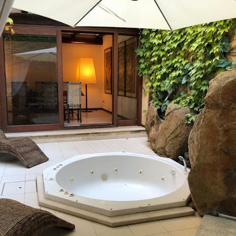 Bathe in the intimate outdoor jacuzzi 