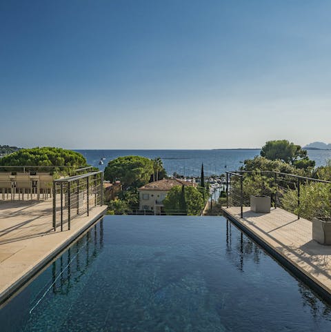 Admire the point where the infinity pool's edge meets the sea view