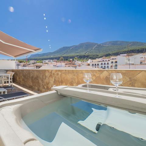 Enjoy a sunset soak in the private hot tub while taking in mountain views