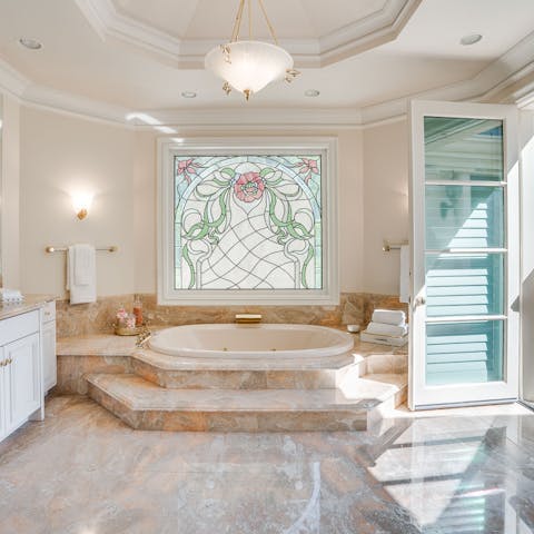 Treat yourself to a morning soak underneath the pretty art-nouveau stained glass window