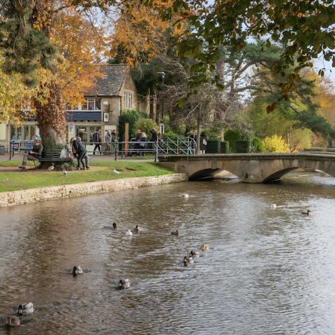 Stroll into Bourton-on-the-Water and grab a drink at the cosy pubs