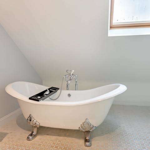 Take a relaxing soak in the rolltop bathtub