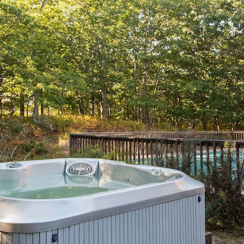 Take in the  woodland views from the hot tub