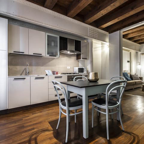 Share a laugh over fresh pasta in this open dining and kitchen space