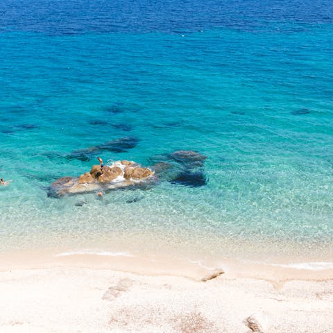 Spend leisurely days at Psarrou Beach,  an eight-minute drive away