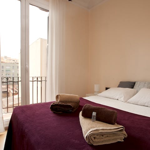 Wake up to Eixample views from the main bedroom's Juliet balcony
