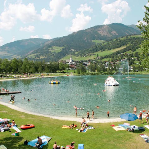 Stroll two minutes to the Alpine swim lake, bursting with activities in summer