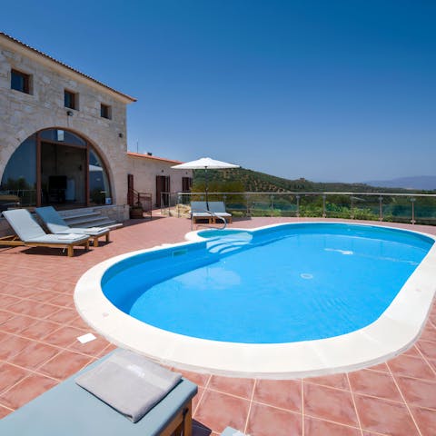 While away sunny afternoons taking dips in the pool with its sea views