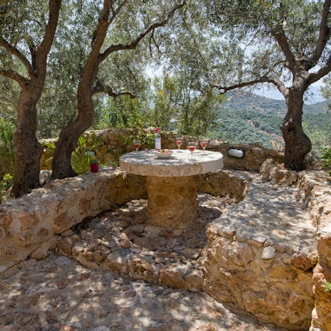 Enjoy a sundowner under the shade of the olive trees