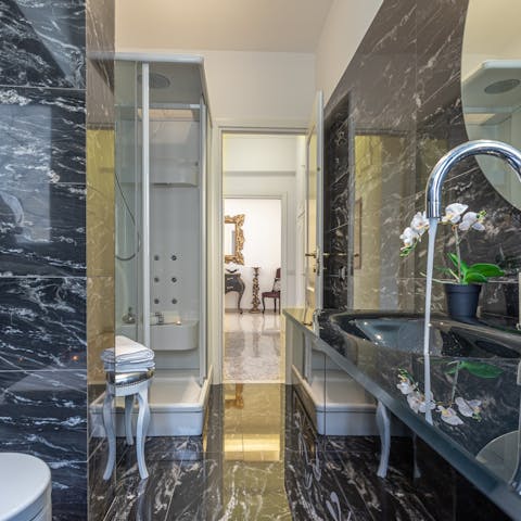 Pamper yourself in the marble-clad bathroom with its rainfall shower