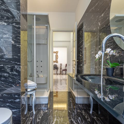 Pamper yourself in the marble-clad bathroom with its rainfall shower