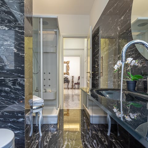 Pamper yourself in the marble-clad bathroom with its rainfall shower