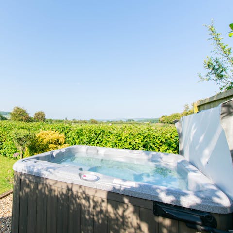 Savour beautiful views while relaxing in the private hot tub 