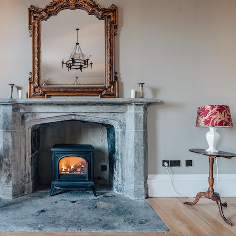 Light up the wood-burning fire to keep cosy by the marble fireplace