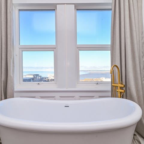 Treat yourself to a relaxing bath with views in this freestanding tub
