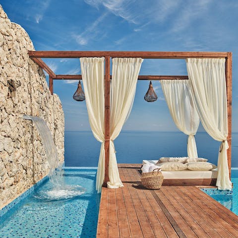 Soak up the sun from the daybed to the soft sound of the water feature