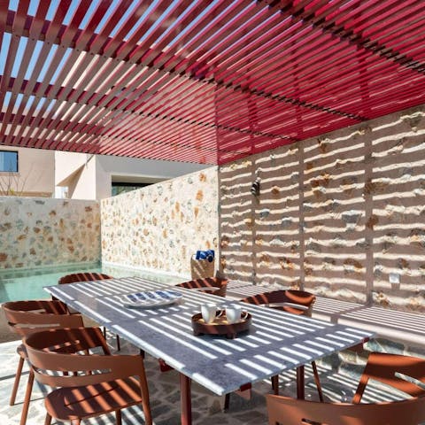 Gather around the table for a Greek feast under the pergola
