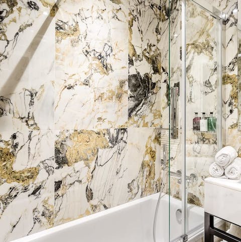 Indulge in a long soak in the marble-clad bathroom, where you'll find luxury Molton Brown toiletries