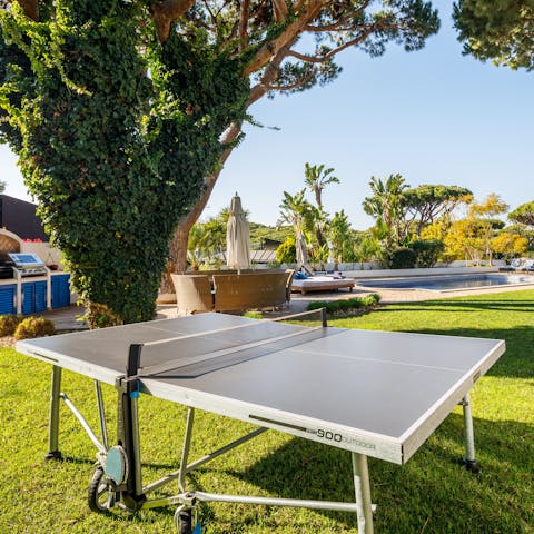 Enjoy a game of table tennis in the tropical garden