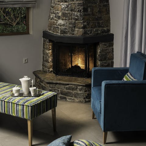 Get cosy with a cup of tea by the fireplace