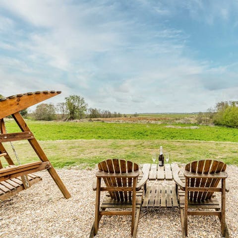 Pop the fizz and celebrate the stunning views from your spot outside