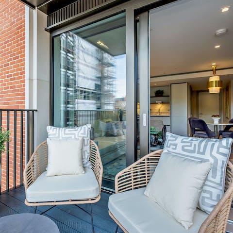 Share alfresco drinks on the private balcony to end a busy day