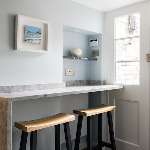 Sit up at the beautiful quartz breakfast bar