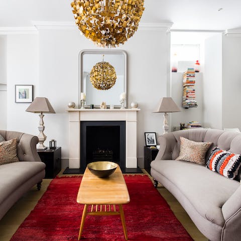 Relax around the fireplace in the plush living room