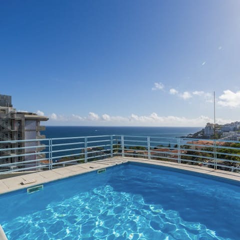 Cool off on hot, sunny days in the shared rooftop pool, offering lovely views of the ocean
