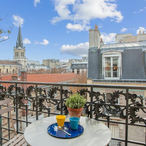 Sip your morning coffee and admire the view of Parisian rooftops and the local church