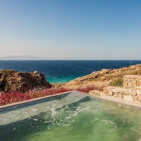 Gaze out at the glistening ocean from your private infinity pool
