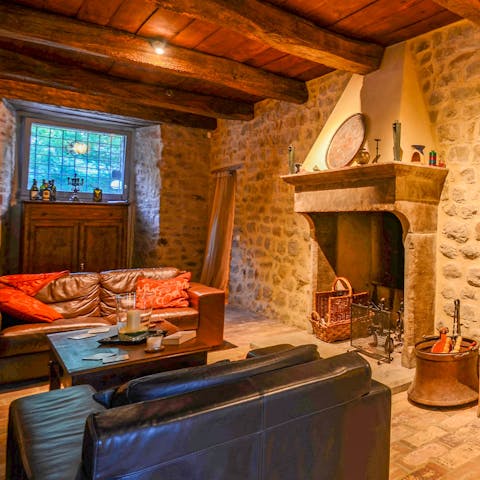 Spend an evening fireside in this rustic living room with its comfortable leather sofas