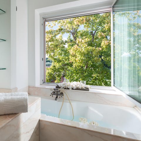 Soak in the tub with verdant garden views