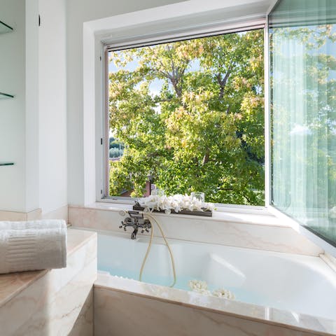 Soak in the tub with verdant garden views