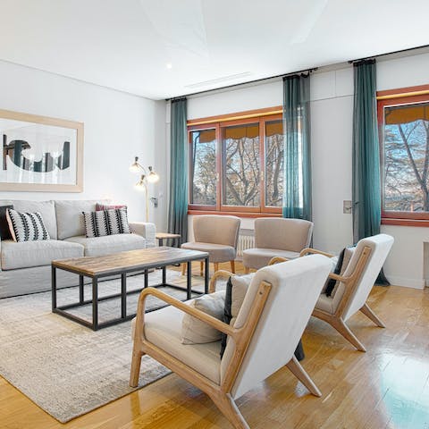 Get comfy in the stylish living room with windows overlooking the beautiful Parque del Oeste