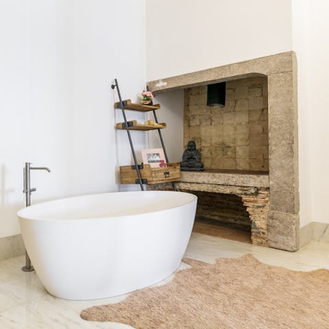 Soak in the freestanding tub in the stripped-back bathroom 