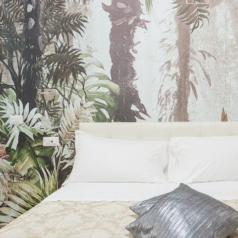 Nod off in the sumptuous bed underneath striking jungle-print wallpaper 