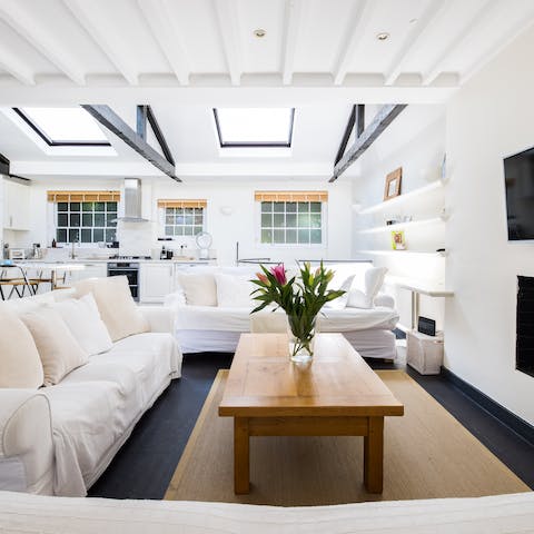 Soak up the skylights that brighten the white living room