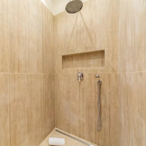 Relax and unwind beneath the bathroom's rainfall shower