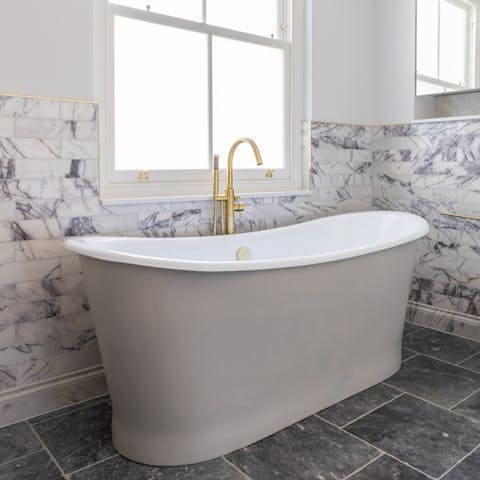 Enjoy a luxurious soak in the freestanding roll top bath