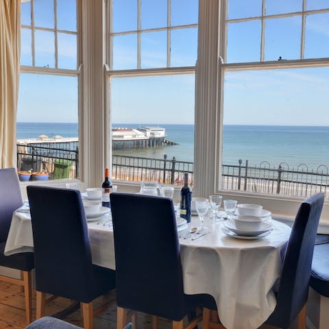 Gather together for dinner with mesmerising views of the sea
