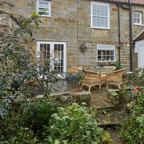 A cute back garden filled with plants